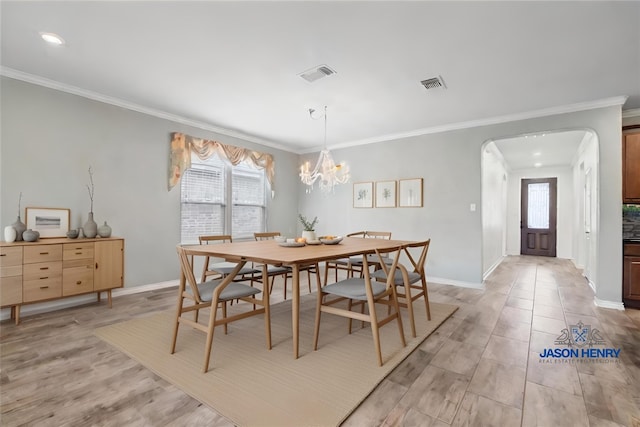 dining area featuring arched walkways, visible vents, and light wood-style flooring