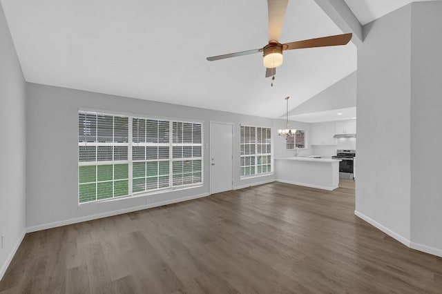 unfurnished living room with hardwood / wood-style flooring, ceiling fan with notable chandelier, and a healthy amount of sunlight