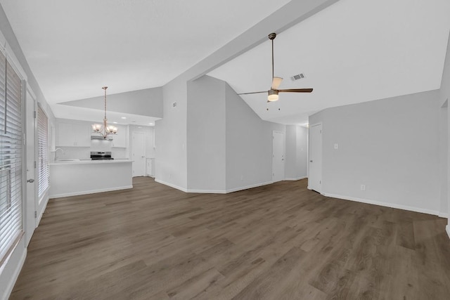 unfurnished living room with ceiling fan with notable chandelier, dark wood-type flooring, lofted ceiling, and sink