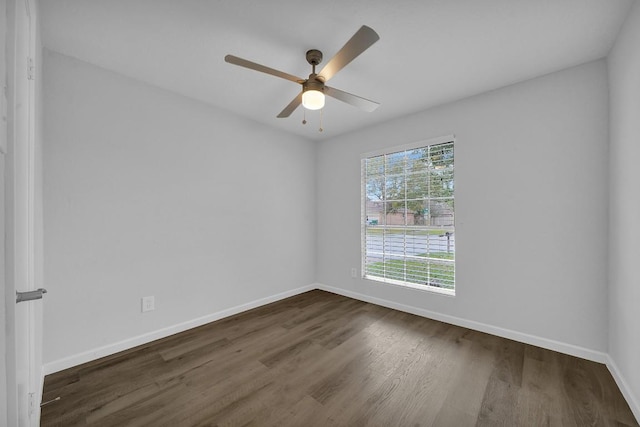 spare room featuring ceiling fan and dark hardwood / wood-style flooring