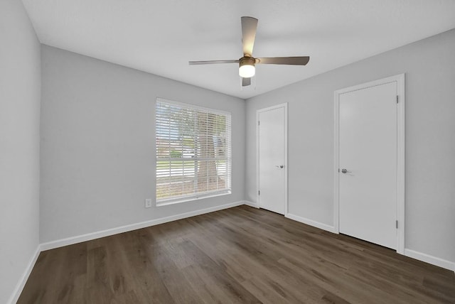 unfurnished bedroom with dark hardwood / wood-style flooring and ceiling fan