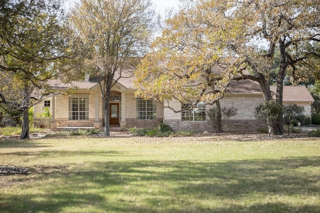 obstructed view of property with a front lawn