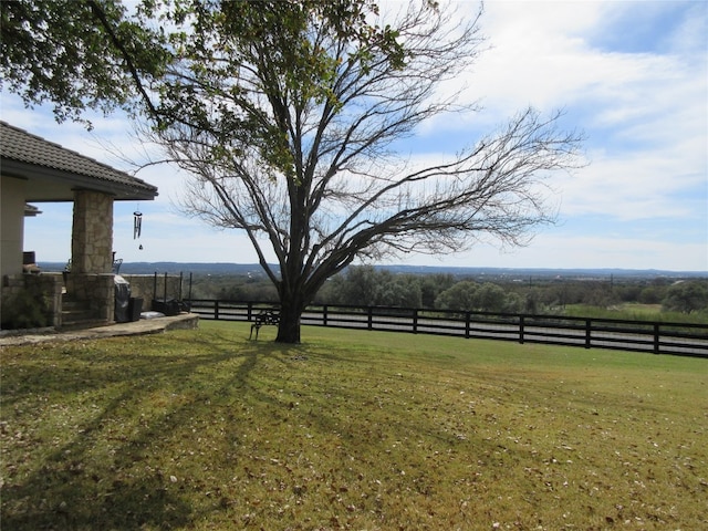 view of yard with a rural view