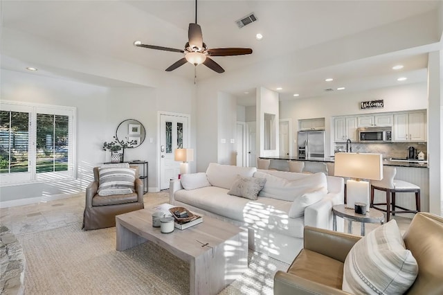 living room featuring ceiling fan and sink