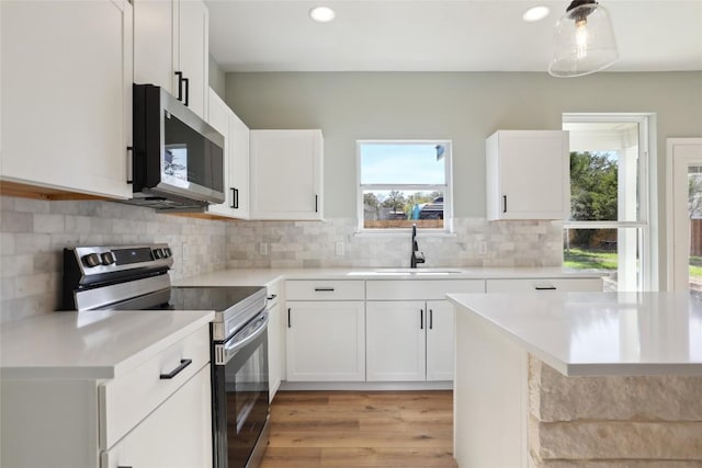 109 Creekside Dr, Bastrop, TX 78602 - kitchen with stainless steel appliances, a sink, healthy amount of natural light, light countertops, and recessed lighting