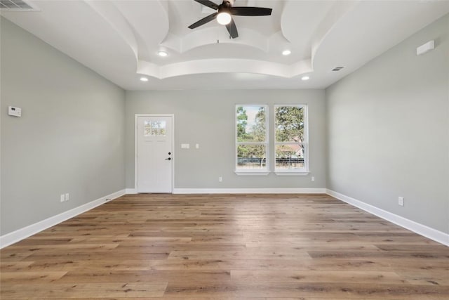 empty room featuring ceiling fan and light hardwood / wood-style flooring