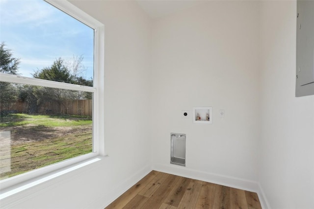 109 Creekside Dr, Bastrop, TX 78602 - laundry area featuring hookup for an electric dryer, baseboards, wood finished floors, and hookup for a washing machine