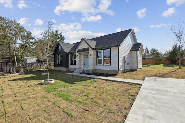 view of front of house featuring an outdoor fire pit and a front lawn