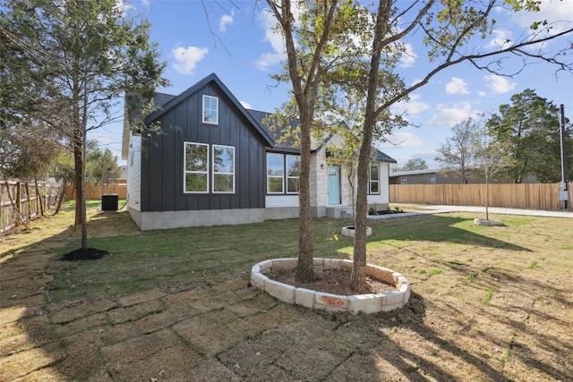 back of house with a lawn