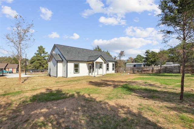 rear view of house with a lawn