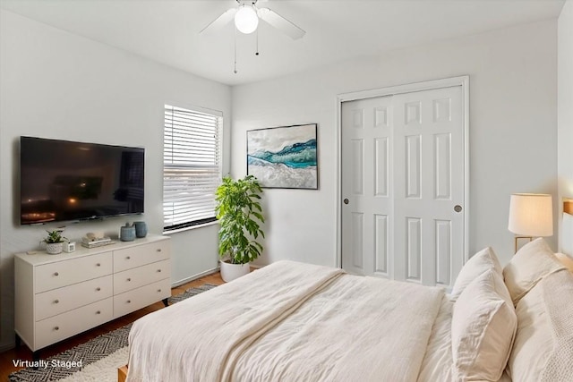 bedroom featuring ceiling fan, a closet, and wood-type flooring