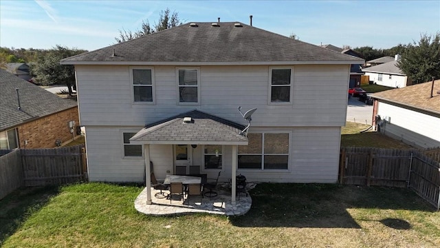 rear view of house featuring a yard and a patio area