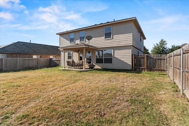 rear view of property with a lawn, a patio area, and ceiling fan