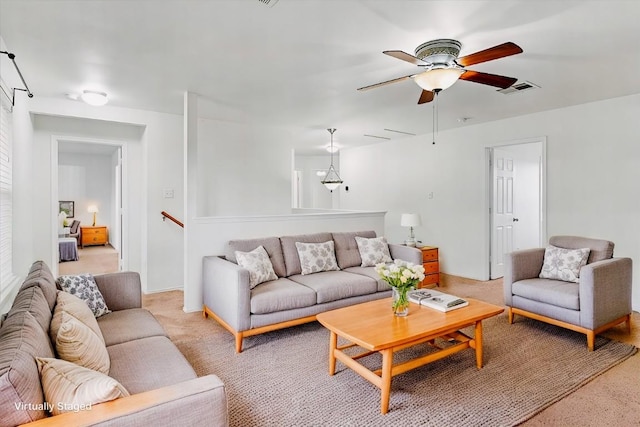 carpeted living room featuring ceiling fan