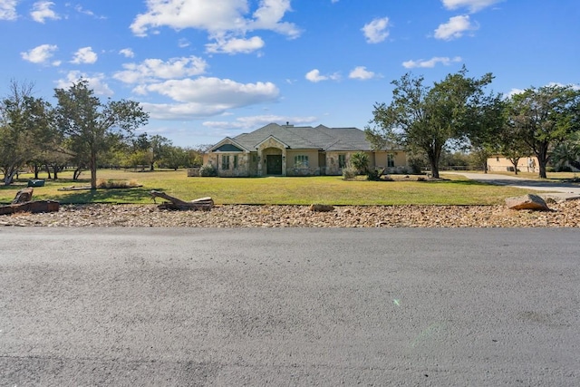 ranch-style home featuring a front yard