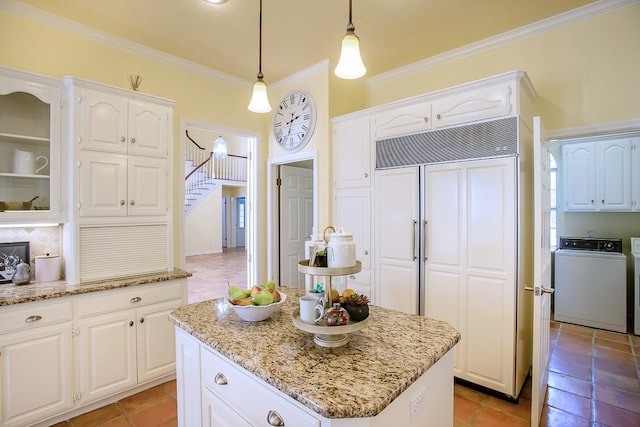 kitchen featuring white cabinets, pendant lighting, and a kitchen island