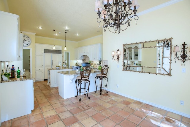 kitchen with kitchen peninsula, white cabinets, pendant lighting, and ornamental molding