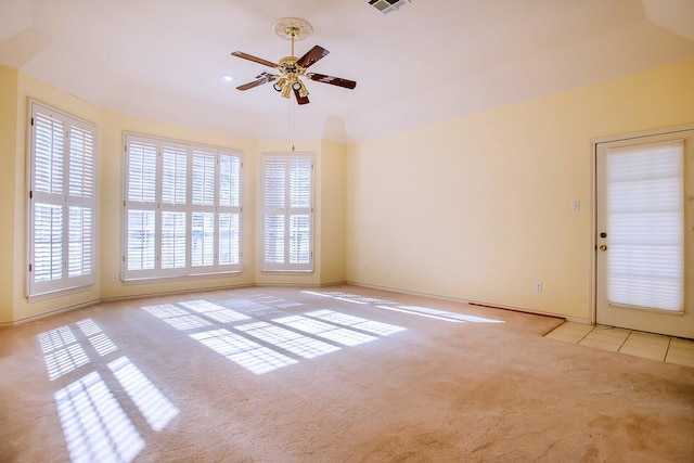 unfurnished room featuring ceiling fan and light carpet