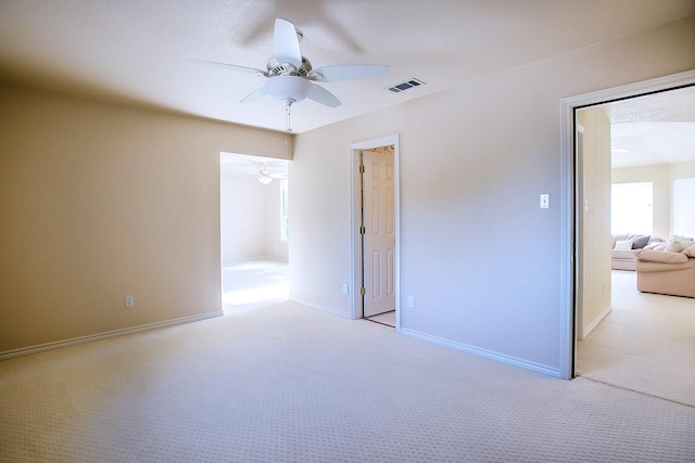 unfurnished bedroom featuring light colored carpet and ceiling fan