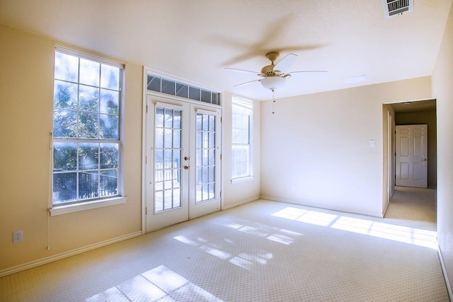 entryway with light carpet, french doors, and ceiling fan