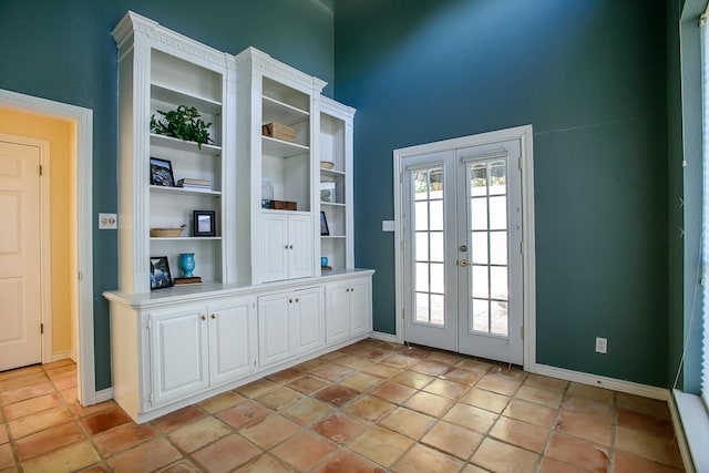 doorway featuring built in shelves, french doors, and light tile patterned floors