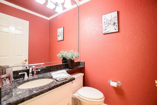 bathroom with vanity, ornamental molding, and toilet