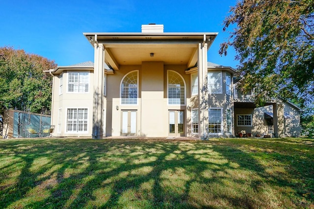 rear view of property with a yard