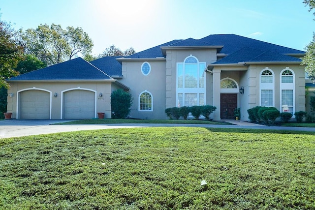 view of front of house featuring a garage and a front lawn