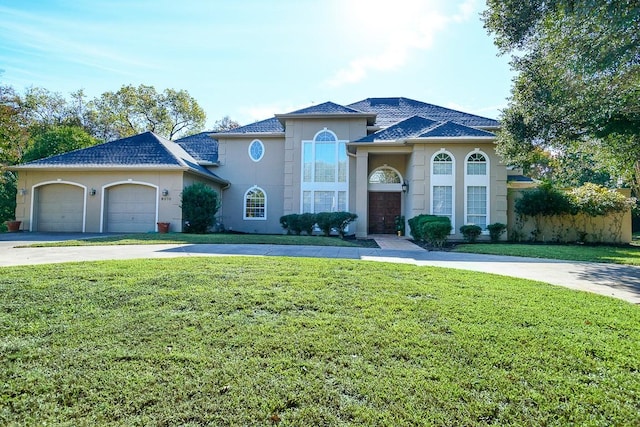 mediterranean / spanish-style house featuring a front lawn and a garage