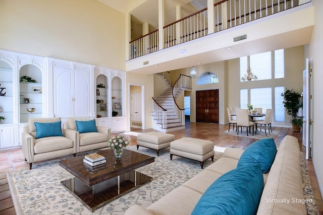 living room featuring built in shelves and a high ceiling