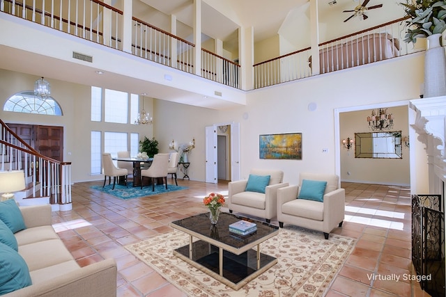 tiled living room featuring ceiling fan and a high ceiling