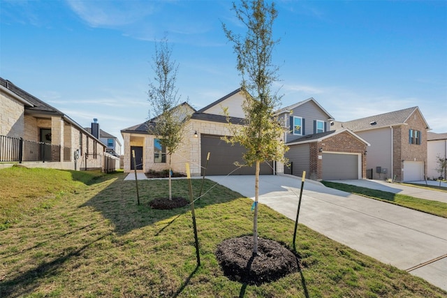 12521 Orchard Grove Ln, Manor, TX 78653 - view of front of home featuring driveway, an attached garage, a front lawn, and brick siding