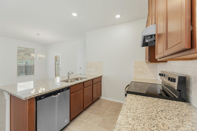 kitchen with exhaust hood, hanging light fixtures, sink, appliances with stainless steel finishes, and kitchen peninsula