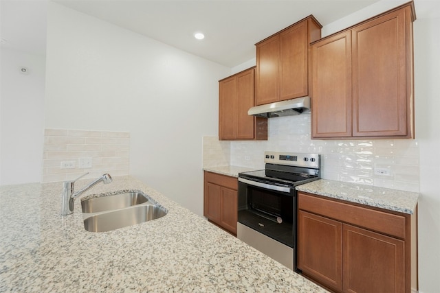 12521 Orchard Grove Ln, Manor, TX 78653 - kitchen featuring electric range, under cabinet range hood, a sink, light stone counters, and backsplash
