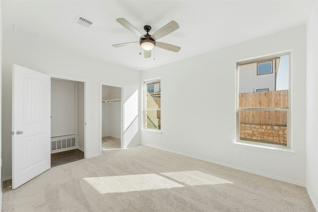 unfurnished bedroom featuring ceiling fan and light colored carpet