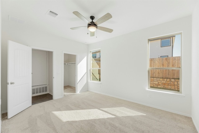12521 Orchard Grove Ln, Manor, TX 78653 - unfurnished bedroom with carpet, baseboards, a spacious closet, and a ceiling fan