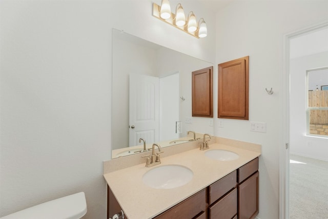 12521 Orchard Grove Ln, Manor, TX 78653 - bathroom with double vanity and toilet