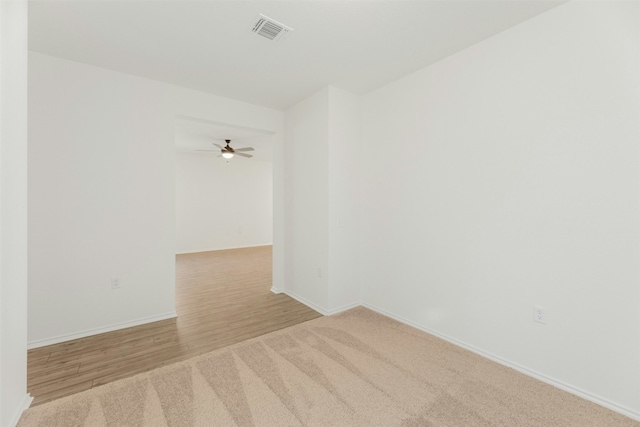 empty room with light hardwood / wood-style flooring and ceiling fan