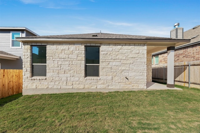 view of side of property with a yard