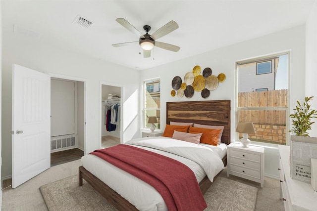 12521 Orchard Grove Ln, Manor, TX 78653 - carpeted bedroom with a ceiling fan, a walk in closet, and a closet