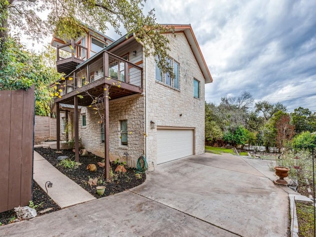 view of property exterior featuring a balcony and a garage