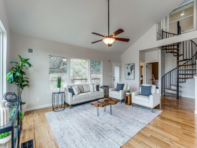 living room featuring ceiling fan, wood-type flooring, and high vaulted ceiling