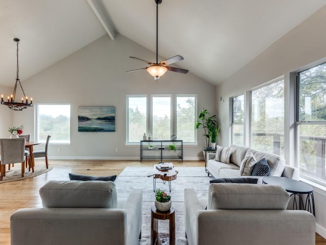 living room with high vaulted ceiling, a healthy amount of sunlight, and light hardwood / wood-style floors