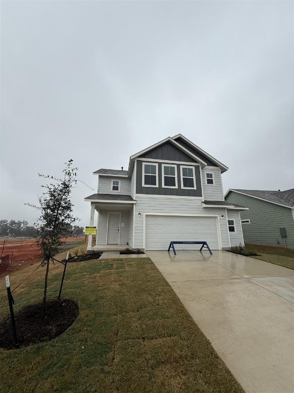 view of property with a front lawn and a garage