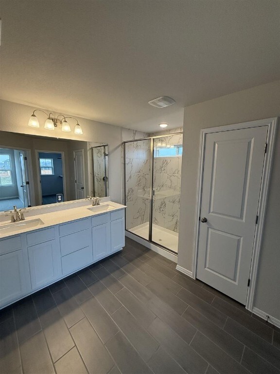 bathroom featuring vanity, wood-type flooring, and walk in shower