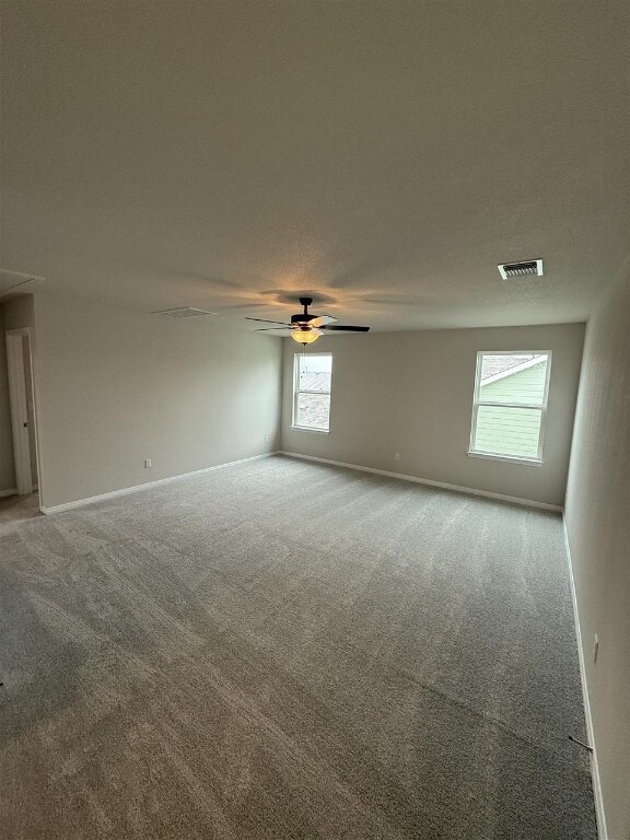 carpeted empty room with ceiling fan