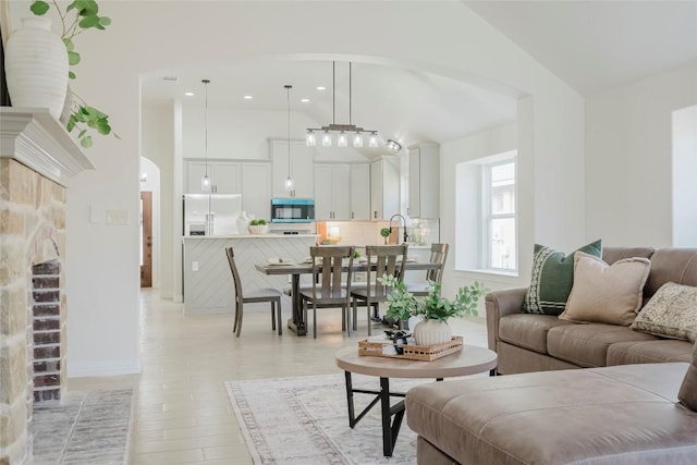 living room with a fireplace and vaulted ceiling