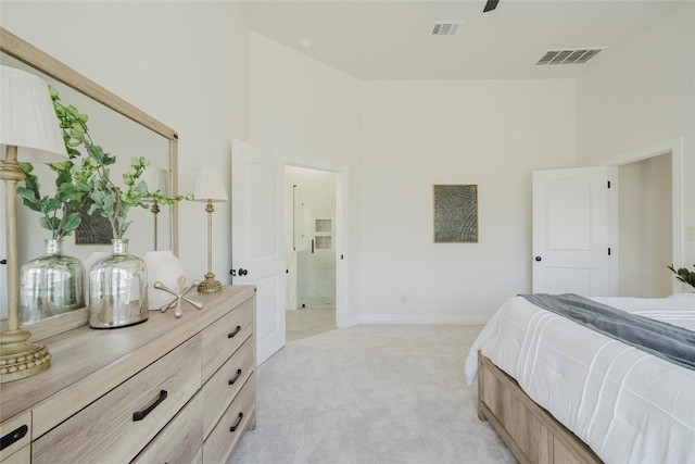 carpeted bedroom featuring a high ceiling