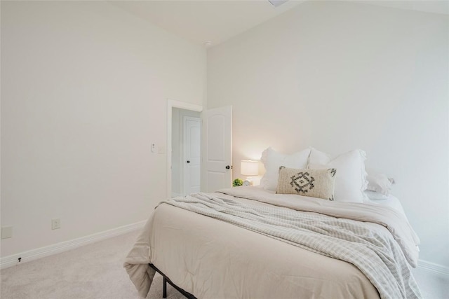 bedroom featuring carpet floors and high vaulted ceiling