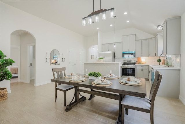 dining space with lofted ceiling and sink